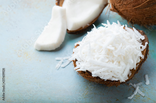 Coconut flakes in a shell on a blue background. with copy space photo