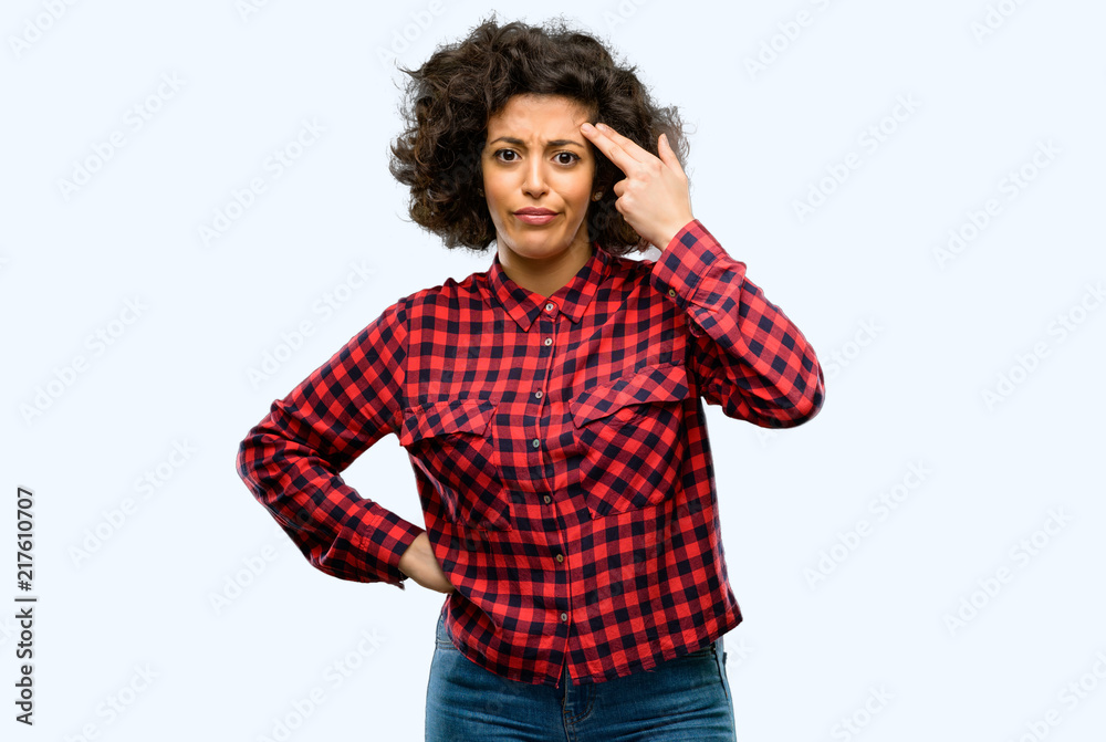 Beautiful arab woman unhappy making suicide gesture, tired of everything. Shoots with hand imitating gun, upset Beautiful arab woman unhappy making suicide gesture, tired of everything. Shoots with hand imitating gun, upset