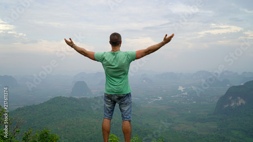 man on top of mountain