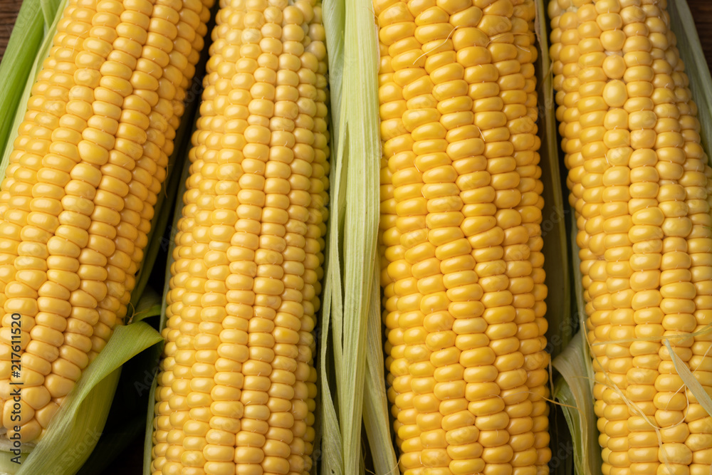 Fresh corn on cobs on rustic wooden table, closeup. Top view Fresh corn on cobs on rustic wooden table, closeup. Top view