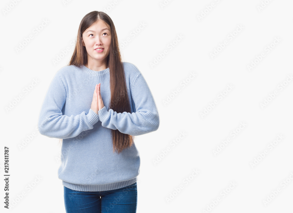 Young Chinese woman over isolated background begging and praying with hands together with hope expression on face very emotional and worried. Asking for forgiveness. Religion concept. Young Chinese woman over isolated background begging and praying with hands together with hope expression on face very emotional and worried. Asking for forgiveness. Religion concept.