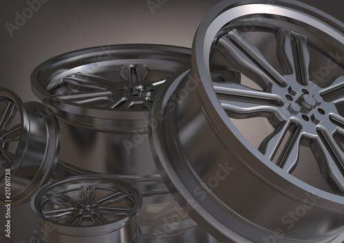 Silvery car wheels on a gray