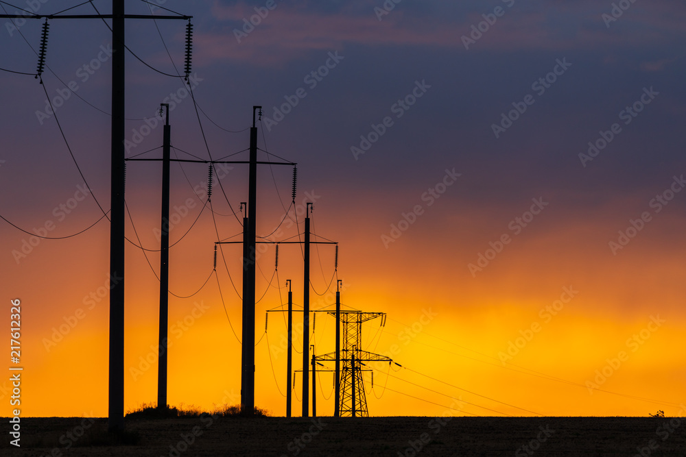 Rural landscape with high-voltage line on sunset