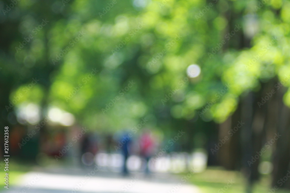 Fototapeta premium Green summer alley park bokeh blur background