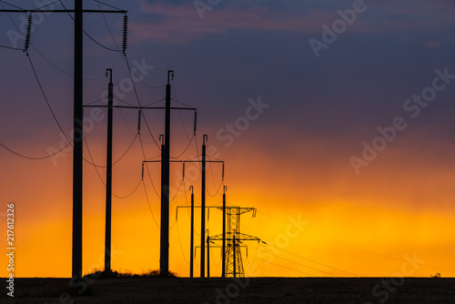 Obraz na płótnie Rural landscape with high-voltage line on sunset w salonie