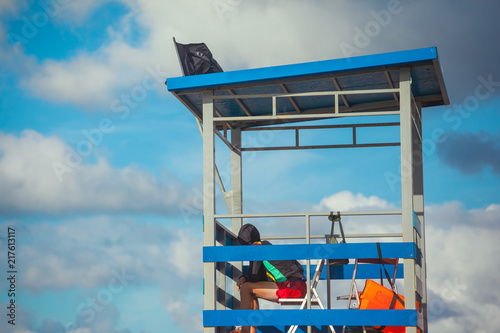 lifeguard on a tower against the blue sky