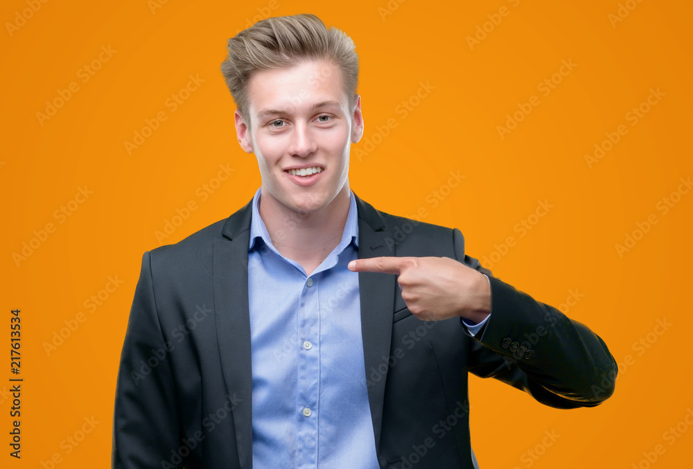 Young handsome blond business man with surprise face pointing finger to himself Young handsome blond business man with surprise face pointing finger to himself