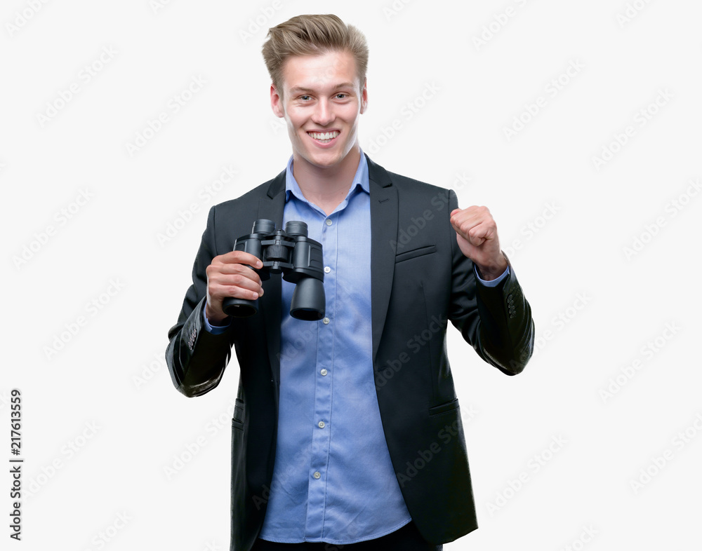 Young handsome blond man looking through binoculars screaming proud and celebrating victory and success very excited, cheering emotion Young handsome blond man looking through binoculars screaming proud and celebrating victory and success very excited, cheering emotion