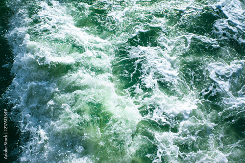 surface of turquoise ocean water with white foam, background, texture