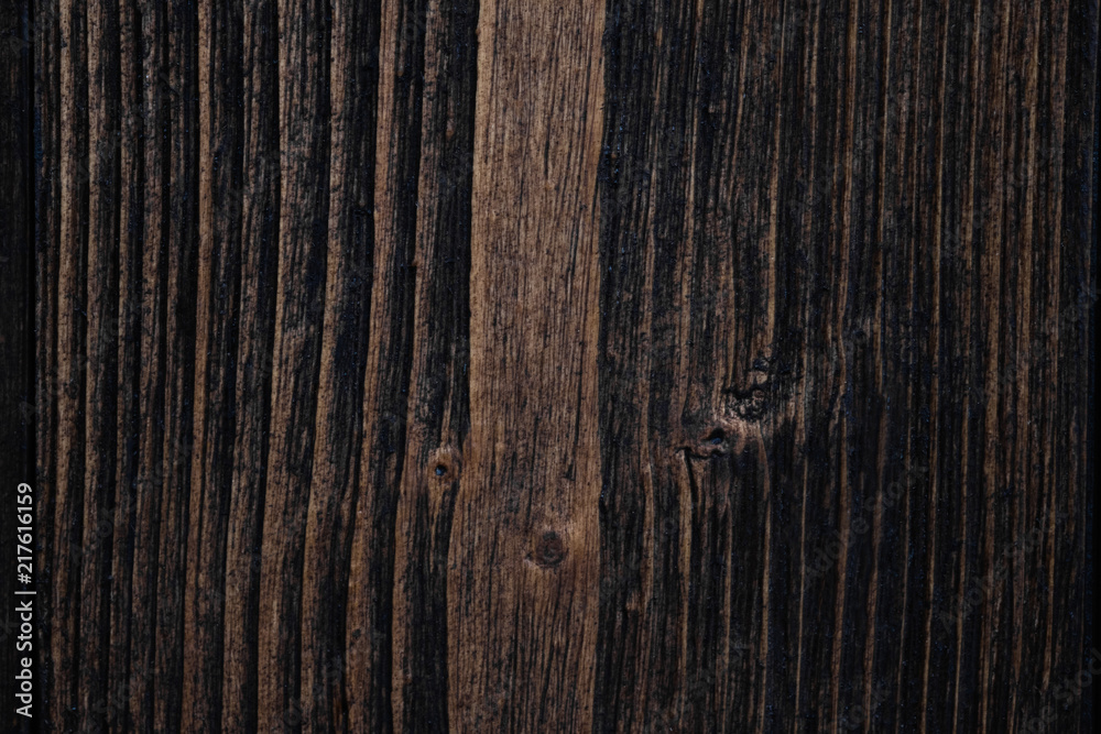 Fototapeta premium Close up of dark brown wood texture with natural striped pattern background