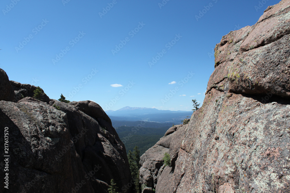 Mountains on horizon looking through large rock structures in Colorado