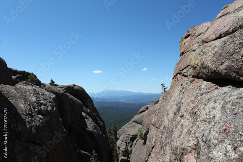 Mountains on horizon looking through large rock structures in Colorado