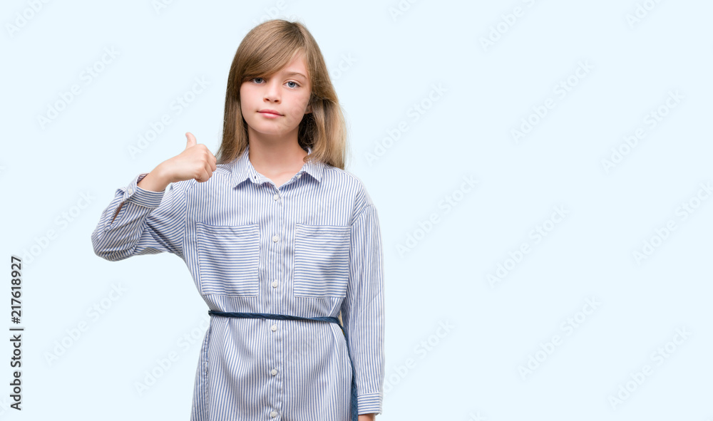 Young blonde toddler wearing blue shirt happy with big smile doing ok sign, thumb up with fingers, excellent sign Young blonde toddler wearing blue shirt happy with big smile doing ok sign, thumb up with fingers, excellent sign