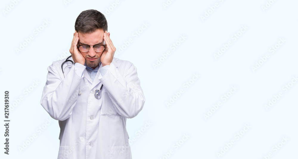 Handsome young doctor man with hand on head for pain in head because stress. Suffering migraine. Handsome young doctor man with hand on head for pain in head because stress. Suffering migraine.