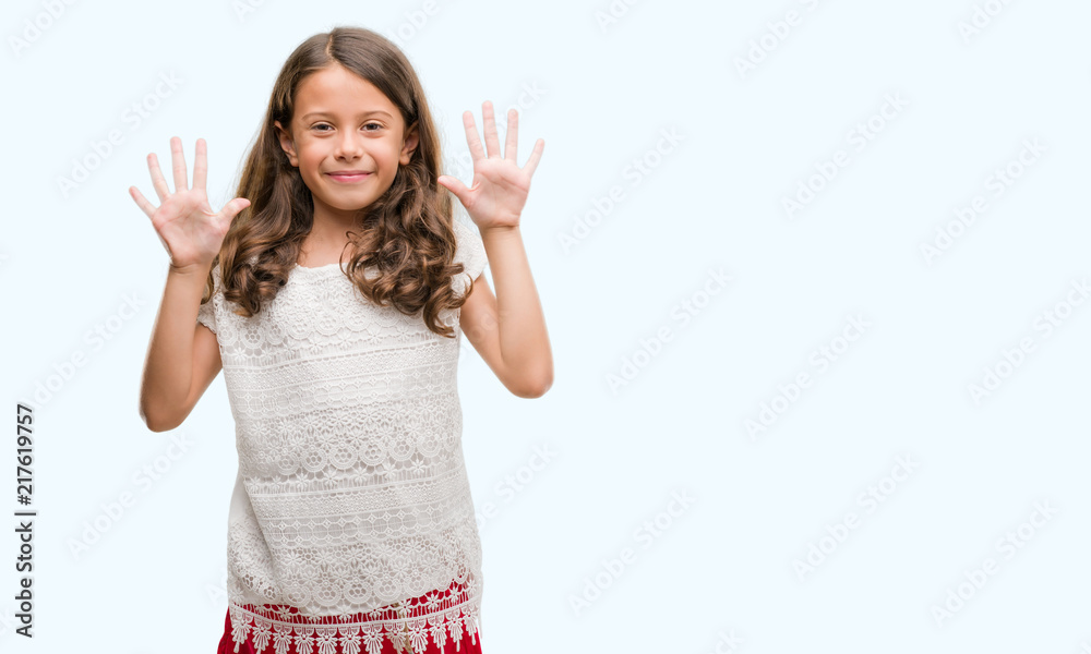Obraz premium Brunette hispanic girl showing and pointing up with fingers number ten while smiling confident and happy.