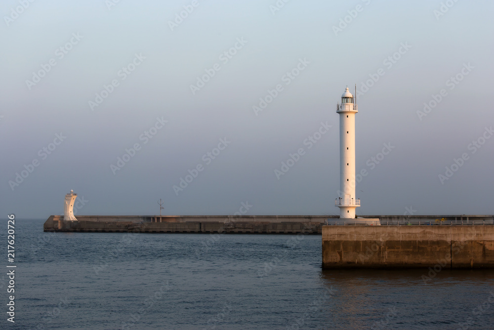 lighthouses in the evening light on the pier