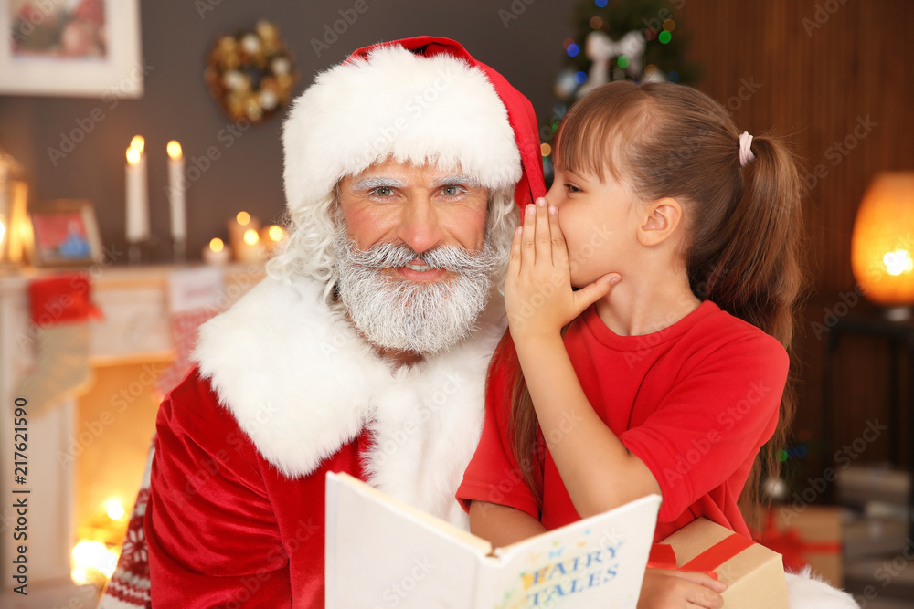 Little child with Santa Claus at home on Christmas day Little child with Santa Claus at home on Christmas day