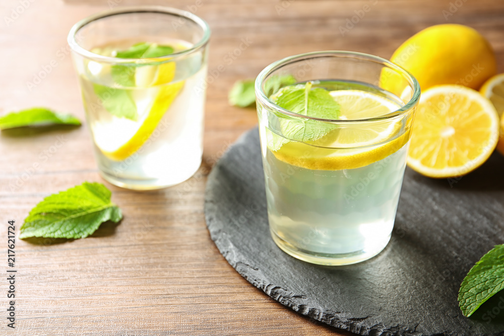 Glass with lemon water on slate plate Glass with lemon water on slate plate
