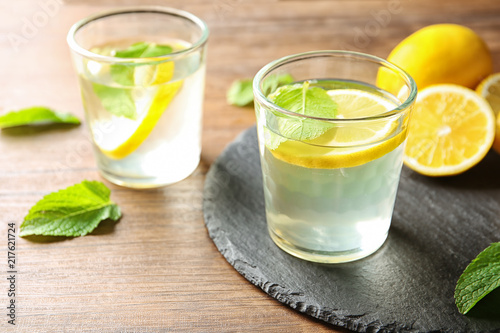 Glass with lemon water on slate plate