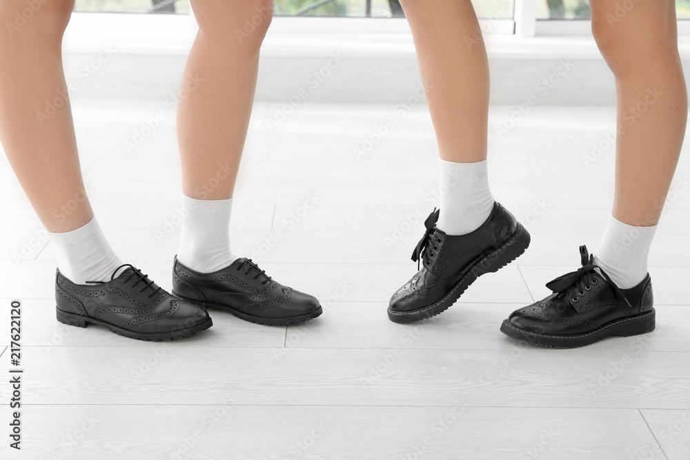 Girls in stylish school uniform indoors, focus on legs