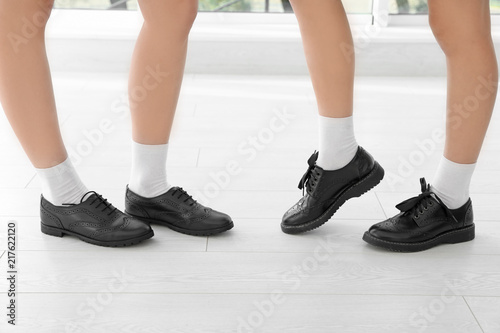 Girls in stylish school uniform indoors, focus on legs