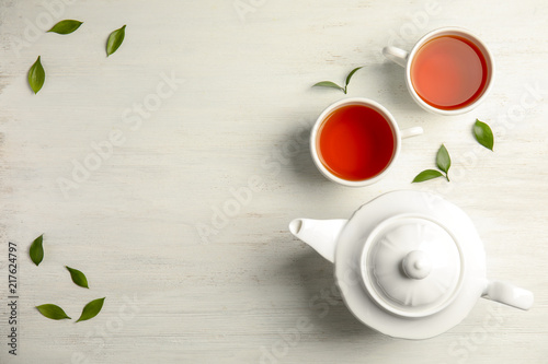 Flat lay composition with delicious tea on wooden background