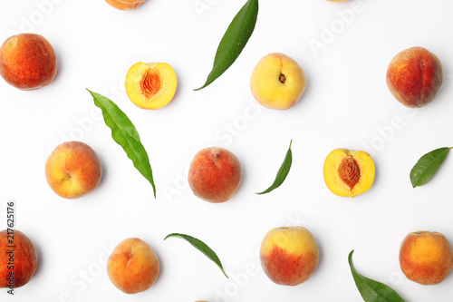 Composition with fresh sweet peaches on white background