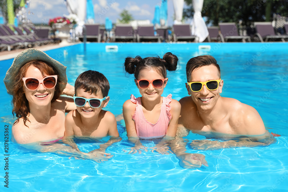 Happy family in swimming pool at resort Happy family in swimming pool at resort