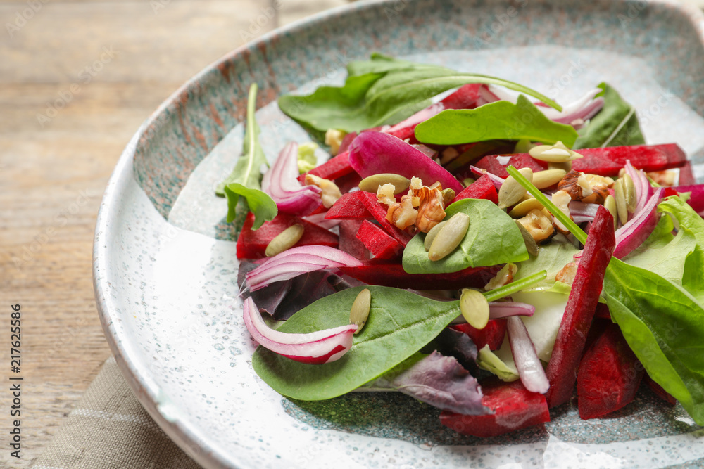 Plate with delicious beet salad on table, closeup Plate with delicious beet salad on table, closeup