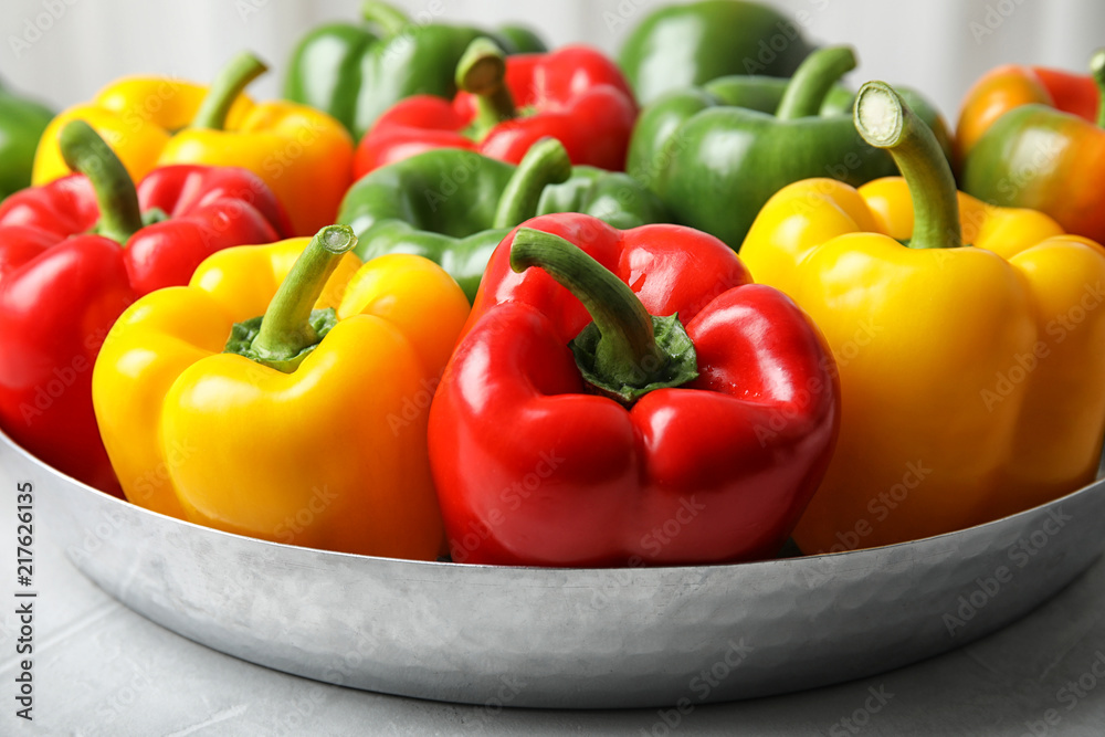 Dish with ripe paprika peppers on table Dish with ripe paprika peppers on table