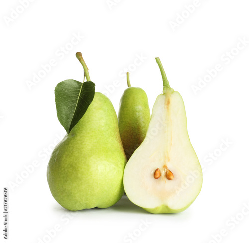 Whole and sliced pears on white background