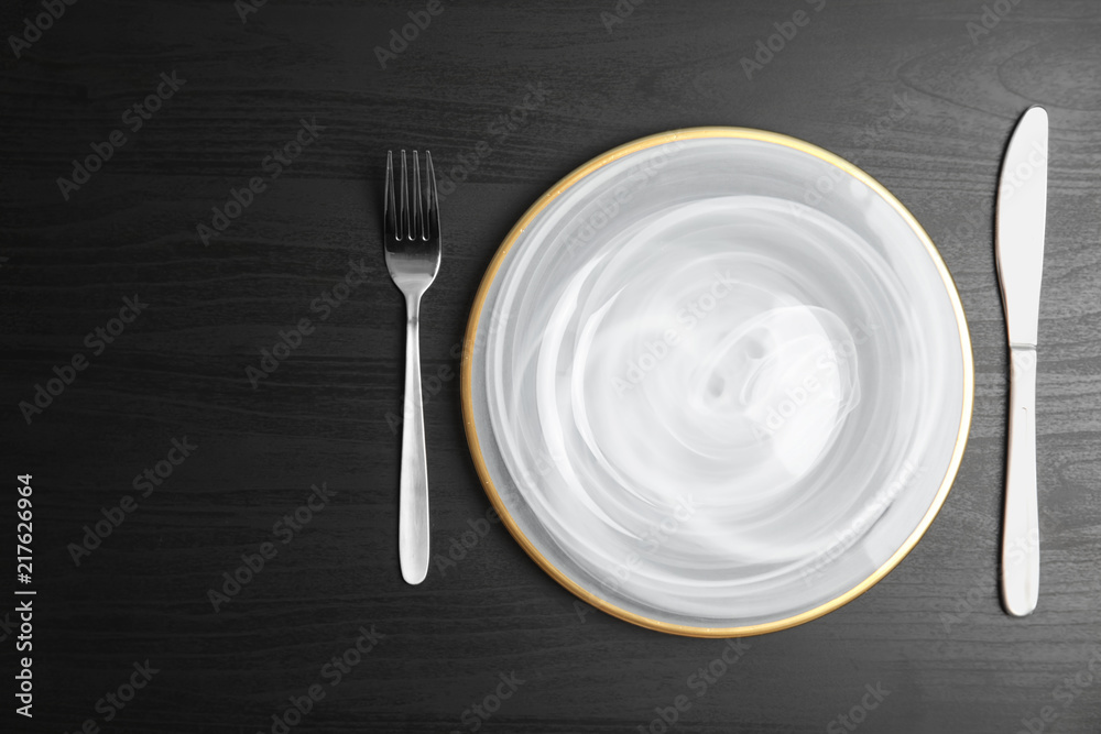 Elegant table setting on dark background, top view