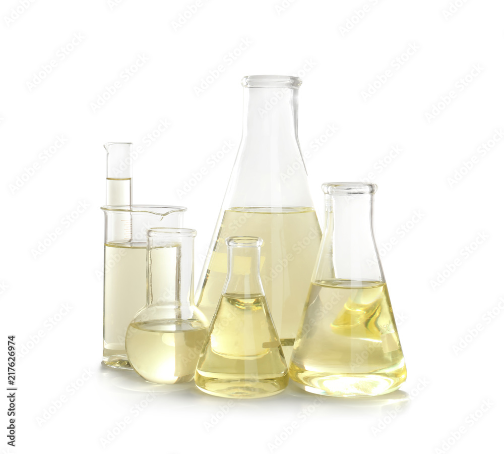 Laboratory glassware with liquid on white background. Chemical analysis