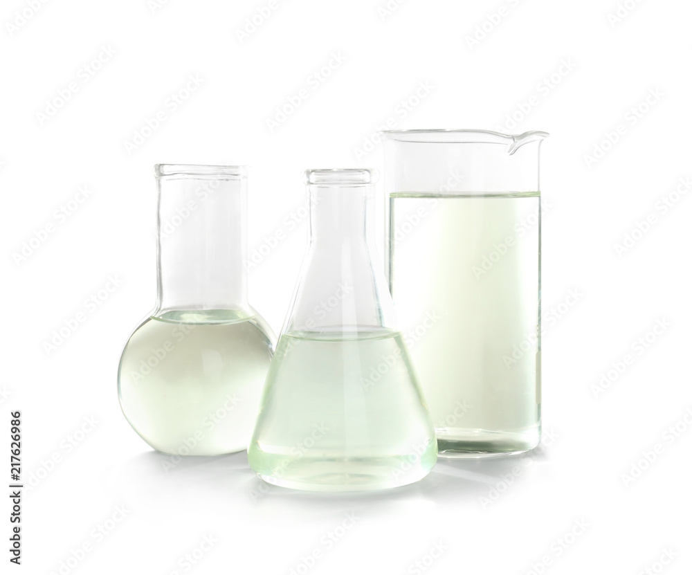 Laboratory glassware with liquid on white background. Chemical analysis