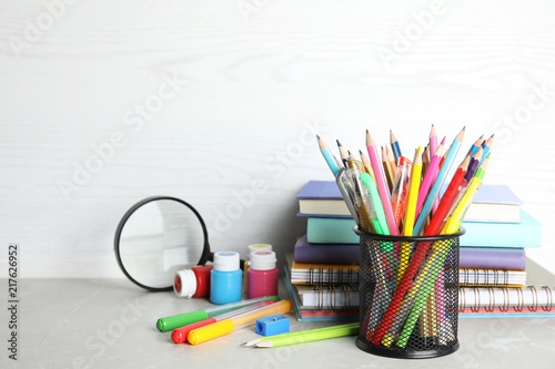Different school stationery on table against light background