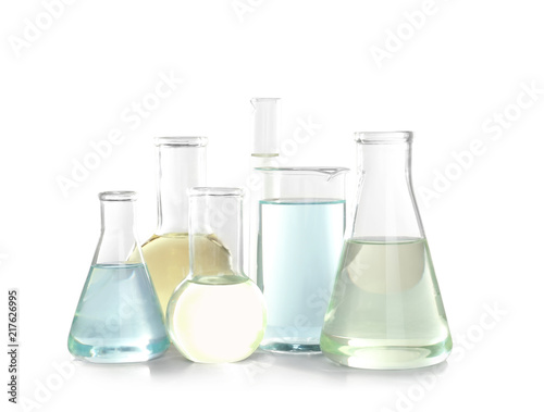 Laboratory glassware with liquid on white background. Chemical analysis