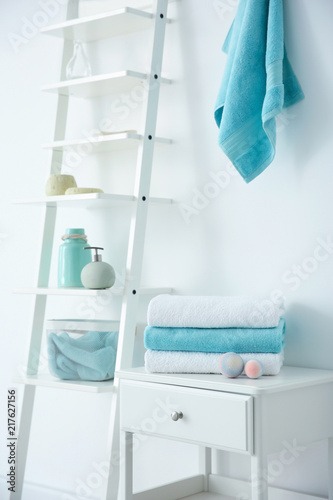 Room interior with clean towels and toiletries