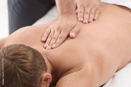 Relaxed man receiving back massage in wellness center © New Africa