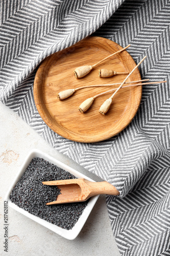 Flat lay composition with poppy seeds on grey background