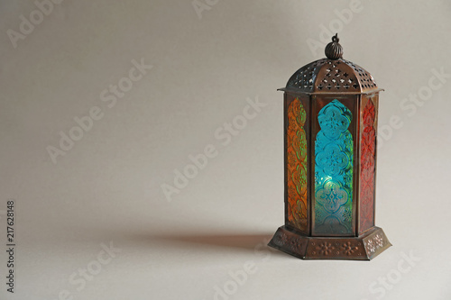 Muslim lamp with candle on light background. Fanous as Ramadan symbol