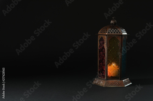 Muslim lamp with candle on black background. Fanous as Ramadan symbol