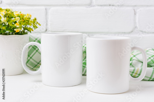 Two coffee mug mockup with yellow and green flowers photo