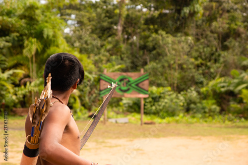 Vászonkép Indian shooting arrow in archery competition in a Brazilian tribe