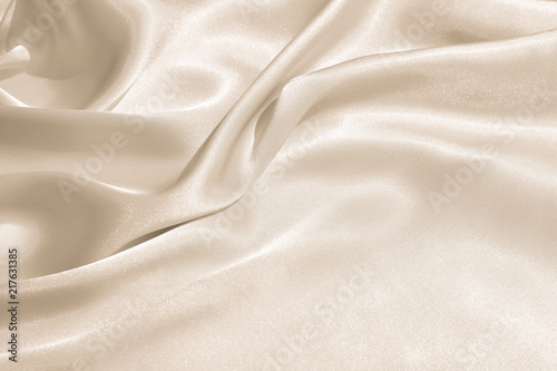 Fototapeta The texture of the satin fabric of beige color for the background