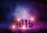 2019 - the symbol of the new year. Abstract background with bokeh, neon light, rays, searchlights. Futuristic sparkling background