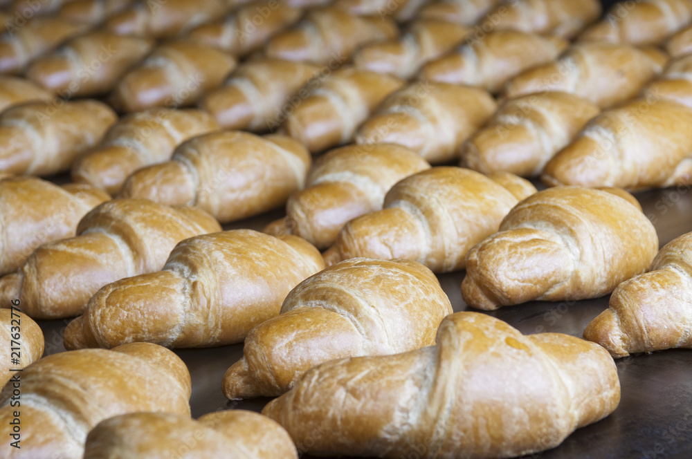 Baked croissants group on the production line