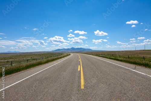 Highway with Sweetgrass Hills near Writing On Stone Provincial Park photo