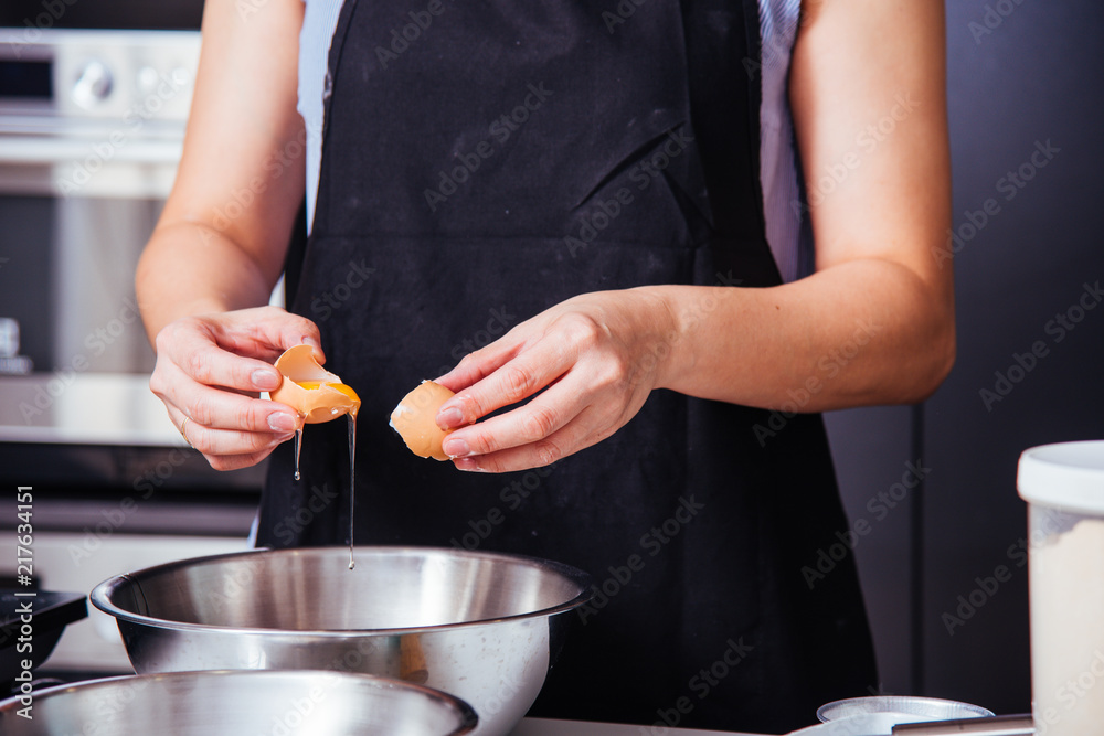 Woman girl baker in kitchen cooking whisk egg to bowl Woman girl baker in kitchen cooking whisk egg to bowl