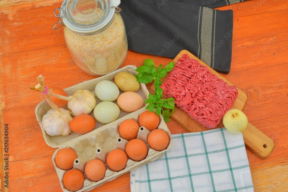 Minced meat, eggs, garlics and onion. Mixed minced meat ready to making burgers, fatty's, meaetballs. Food photography. Culinary concept. Minced meat recipe.