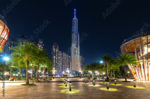 Ho Chi Minh City, Vietnam - August 1st, 2018: Panoramic view of skyscrapers at night with many sparkling lights, below is a central park showing urban development in Ho Chi Minh City, Vietnam © huythoai